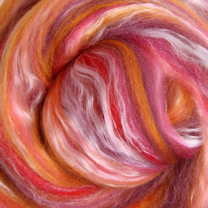 Close-up of shades of red, pink and orange fibre in a swirl pattern