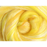 Close up of brilliant yellow fibre with touches of white silk
