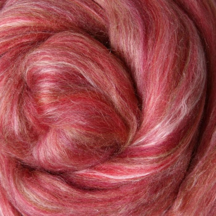 Close-up of a shades of mid toned pink fibre with touches of white silk