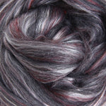 Close-up of merino and silk fibre shades of burgundy red, grays and highlights of white