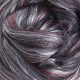 Close-up of merino and silk fibre shades of burgundy red, grays and highlights of white