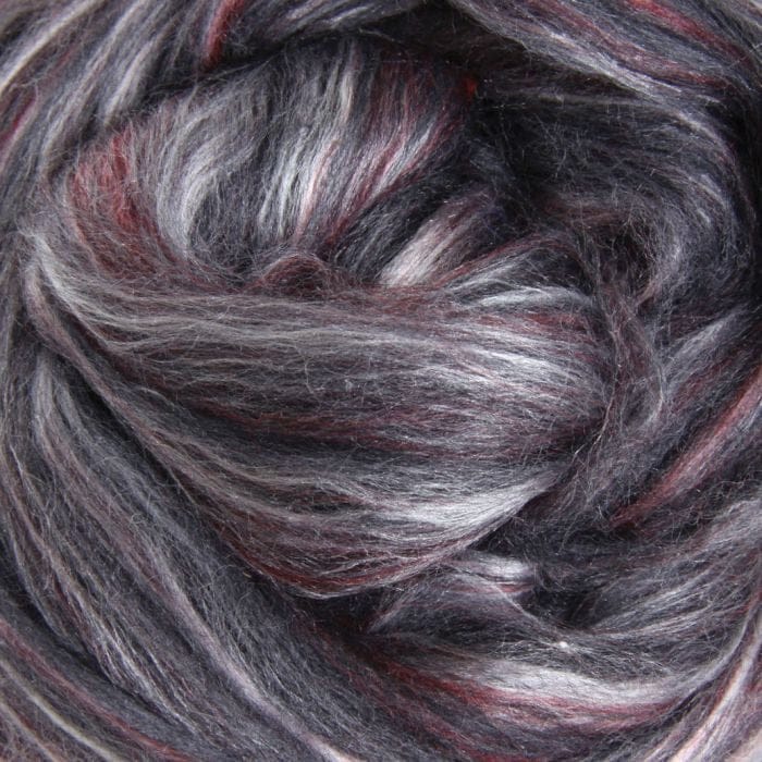 Close-up of merino and silk fibre shades of burgundy red, grays and highlights of white