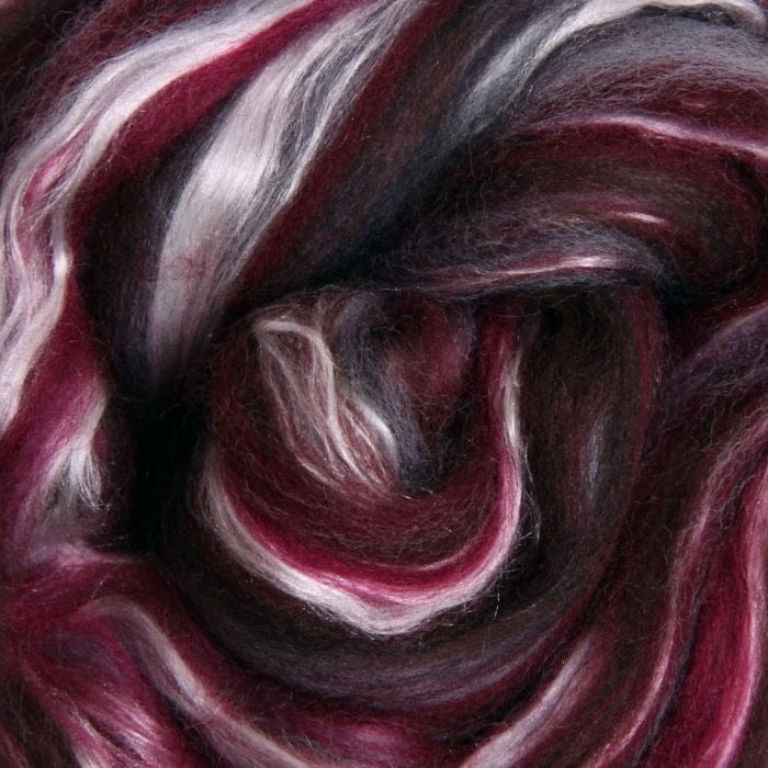 Close-up of maroon merino fibre blended with streaks of gray silk
