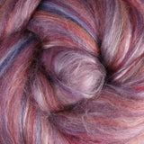 Close-up of merino fibre with shades of purple, pink, and brown with silk highlights
