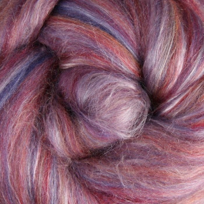 Close-up of merino fibre with shades of purple, pink, and brown with silk highlights
