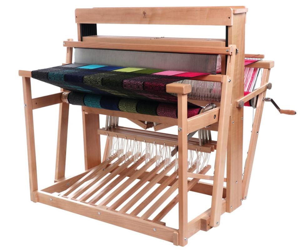 4 shaft weaving loom made from hard wood beech. The loom has a colourful length of fabric on it. 
