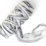 Marbled black and white wool blend fibre on a white background