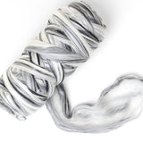 Marbled black and white wool blend fibre on a white background